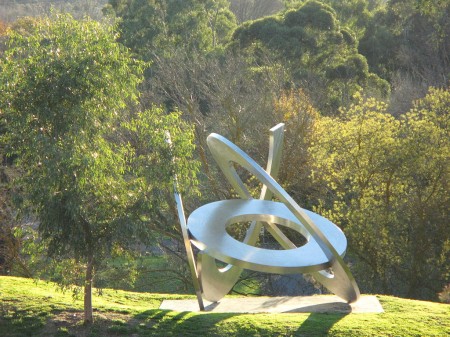 "Rings of Saturn" by Inge King, 2005-06, as displayed in the gardens at the Heide Museum of Modern Art in Bulleen, Melbourne, Australia, viewed from Heide I. Photo taken by Nick Carson in June 2009. WikiCommons Image.